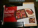 Smokin' Grid W/wood Plank Holder & Grilling Metal Non Stick Finish 14X15". Fixed Price $10.95.